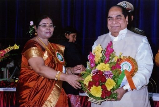 Dr. Gopa Sastri, Presenting a Flower Bouquet to Dr. D. Y. Patil, Hon'ble Governor of Tripura.