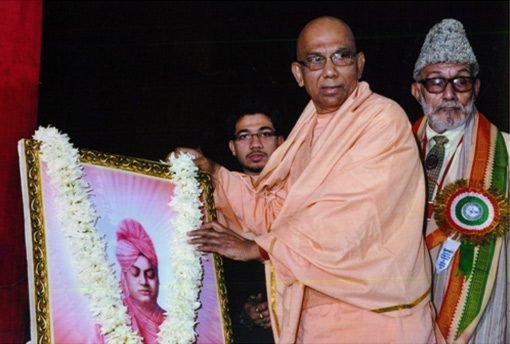 Swami Jitatmananda, Secretary, Ramakrishna Mission, Swami Vivekananda's Ancestral House, garlanding the portrait of Swami Vivekananda, during the Conference.